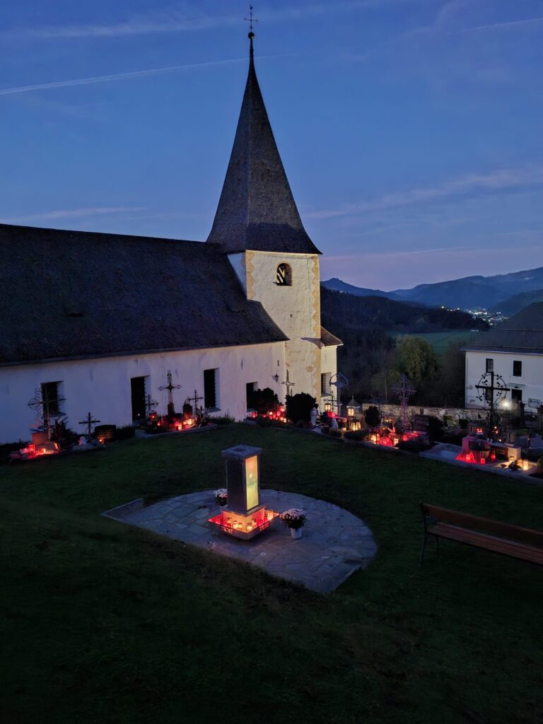 Kunst am Friedhof bei Nacht – leuchtende Gedenkstätte in ruhiger Abendstimmung